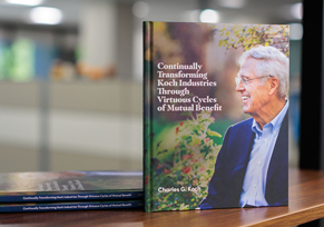 A hardcover copy of Continually Transforming Koch Industries Through Virtuous Cycles of Mutual Benefit by Charles Koch.